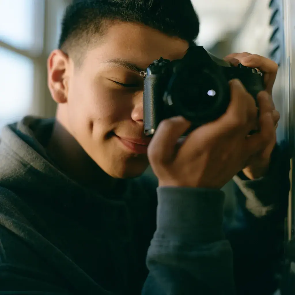 A student photographing with a camera